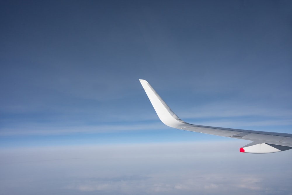 a view of the wing of an airplane in the sky