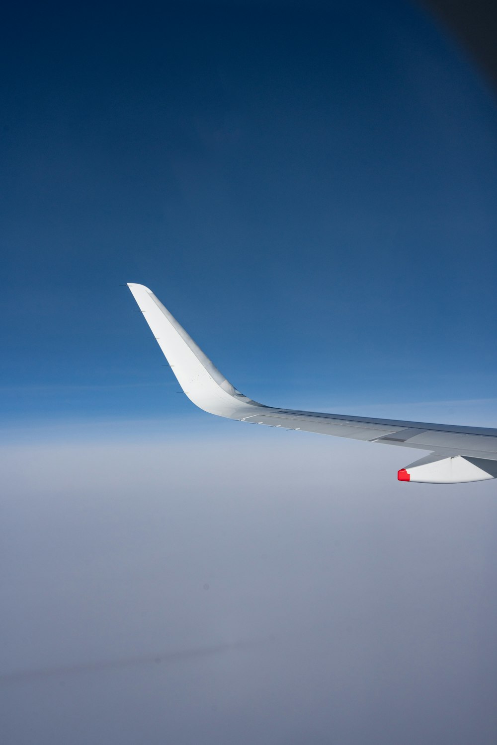 a view of the wing of an airplane in the sky