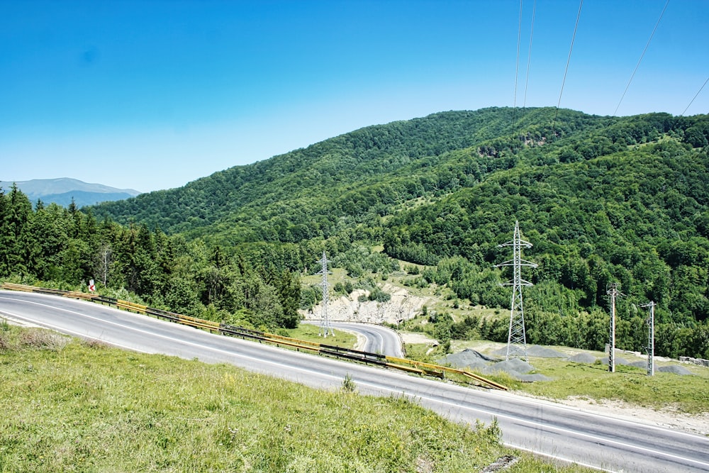 a scenic view of a mountain with a train on the tracks