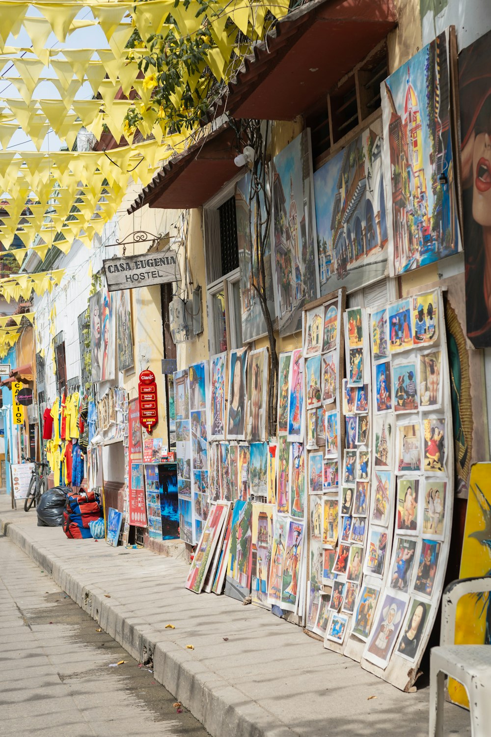 a street with a bunch of posters on the side of it