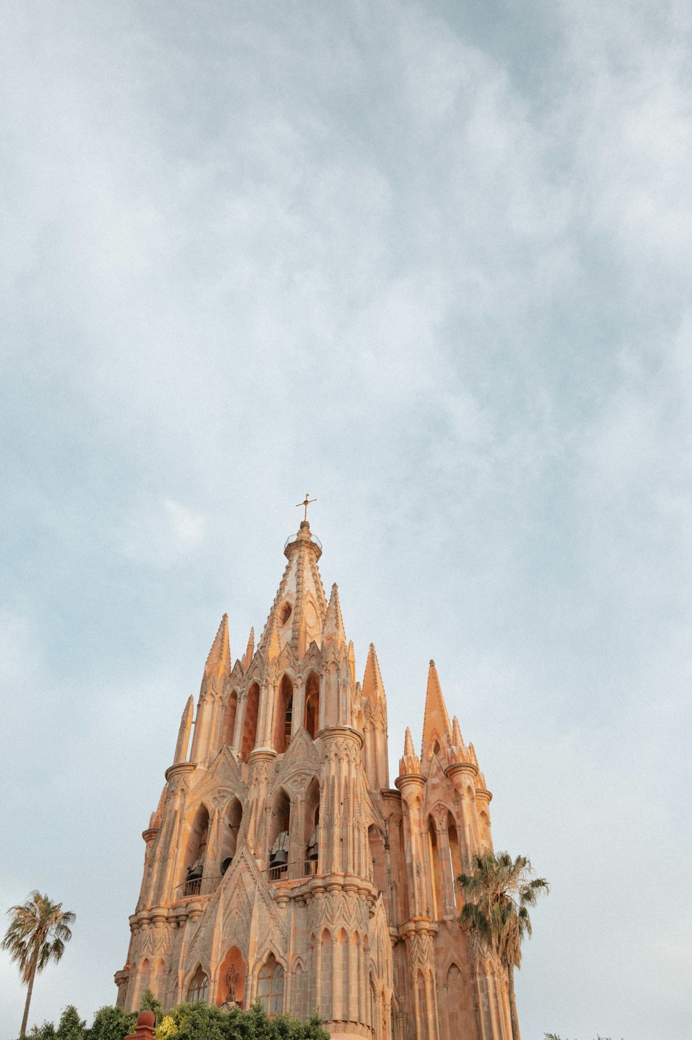 a very tall cathedral with a clock on it's side