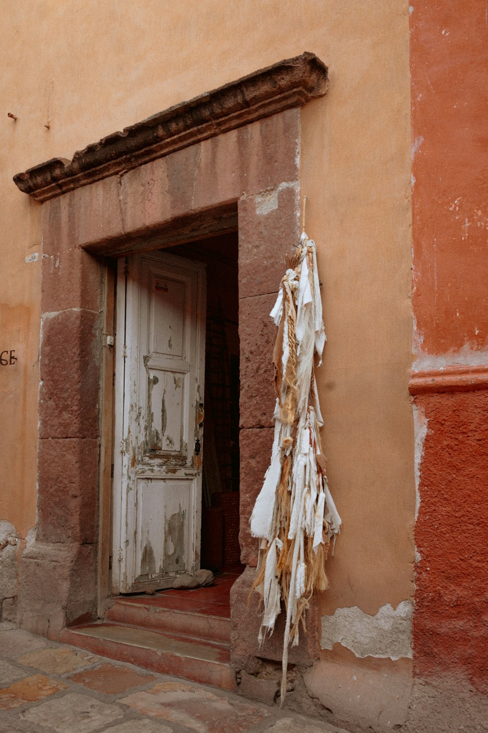 a door with a bunch of pieces of cloth hanging out of it