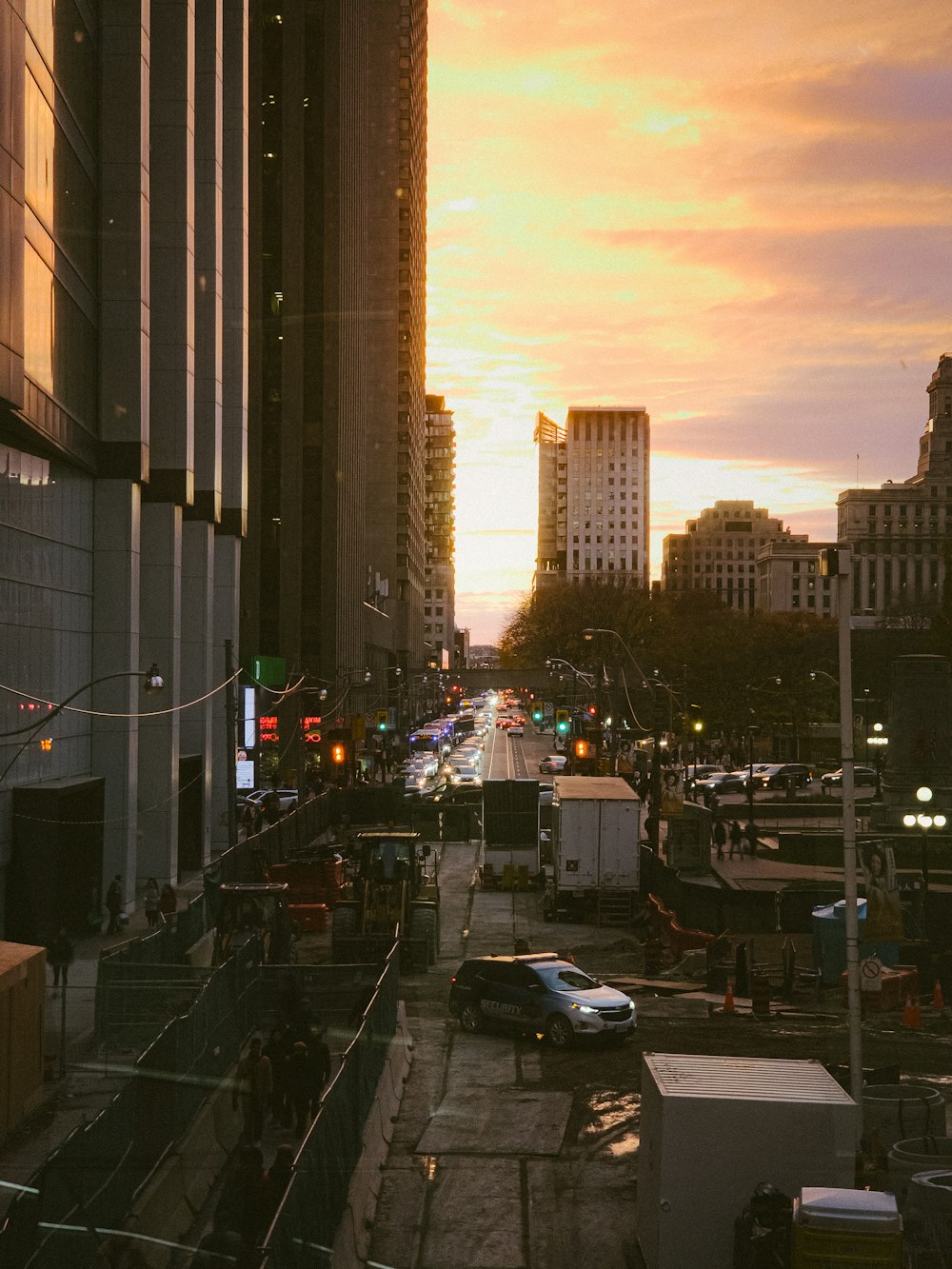 a city street filled with lots of traffic next to tall buildings