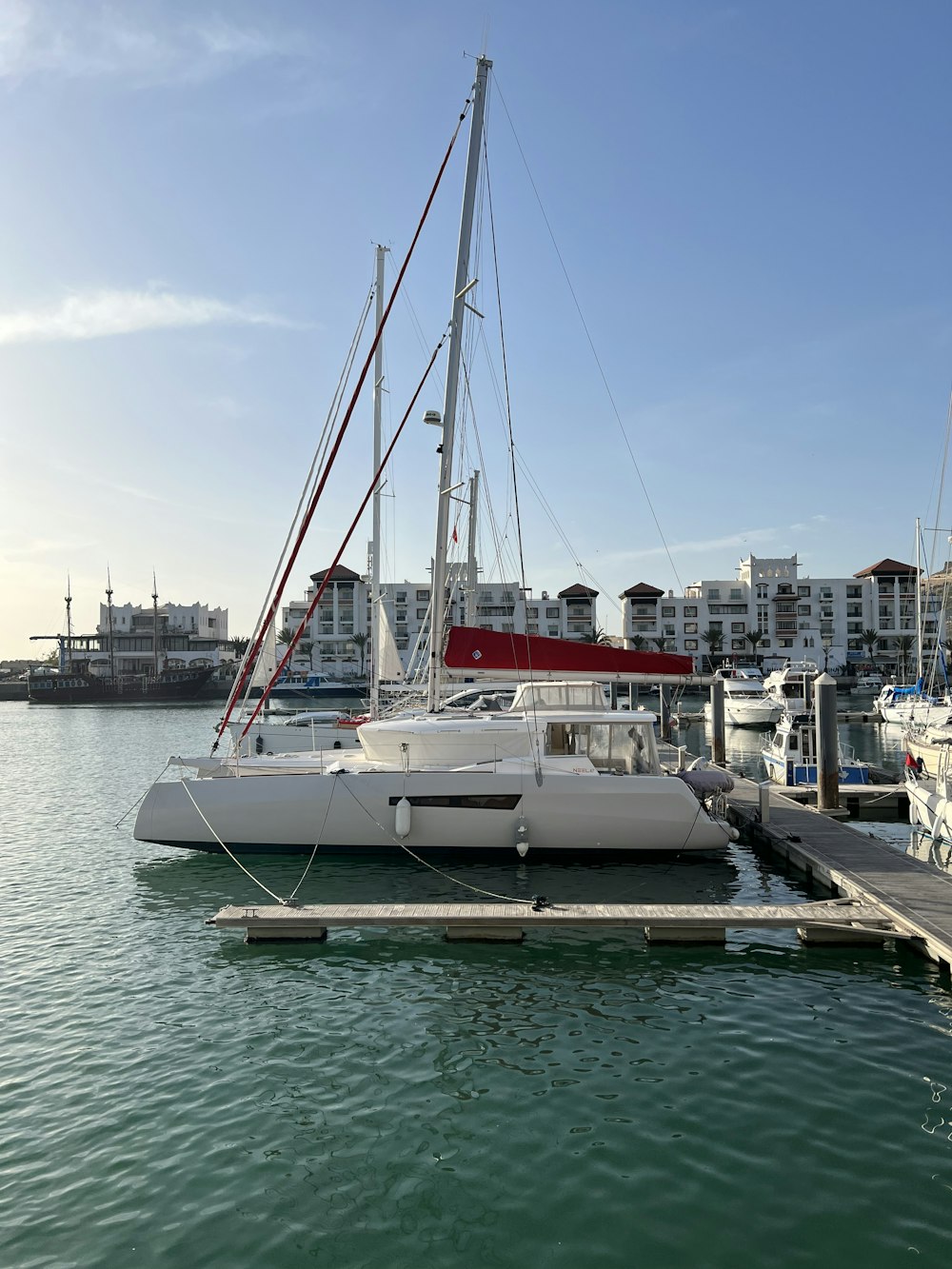 a sailboat docked at a dock in a marina