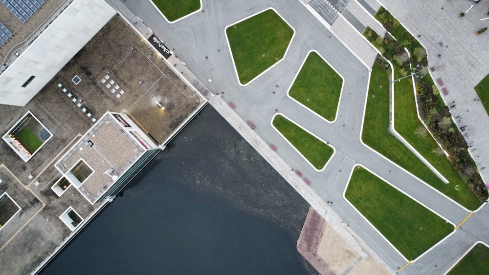 an aerial view of a parking lot and a body of water