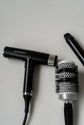 two hair dryers sitting next to each other on a table