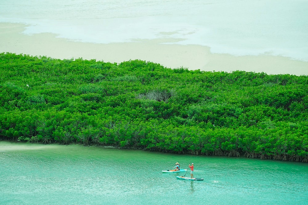 a man riding a surfboard on top of a body of water