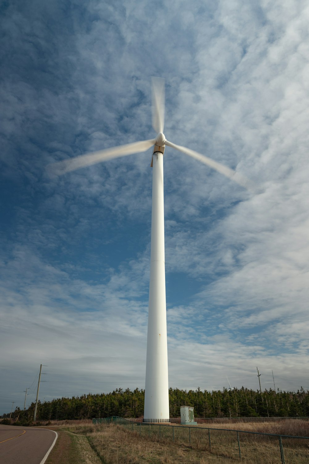 a wind turbine on the side of a road