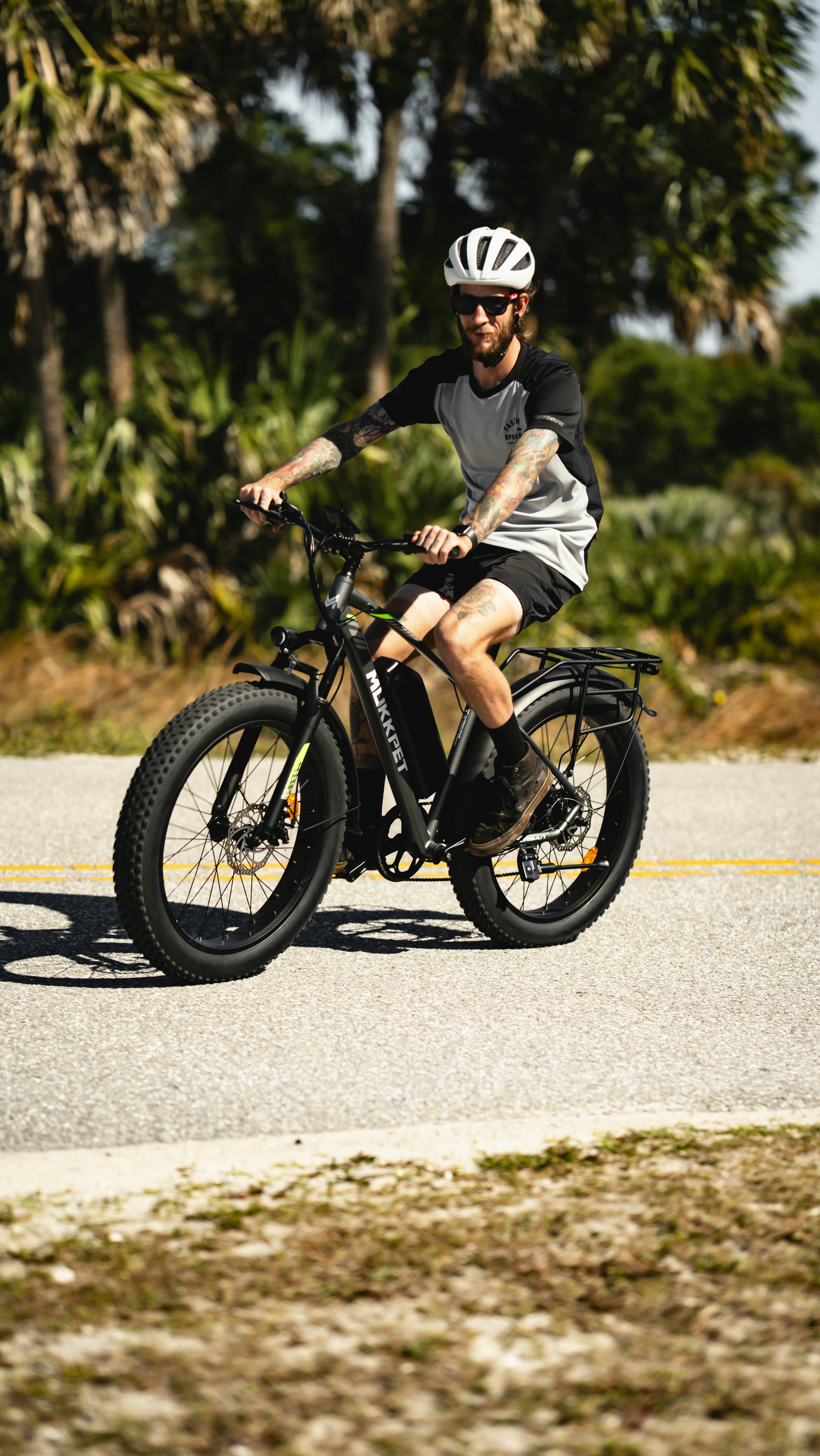a man riding a bike down a street