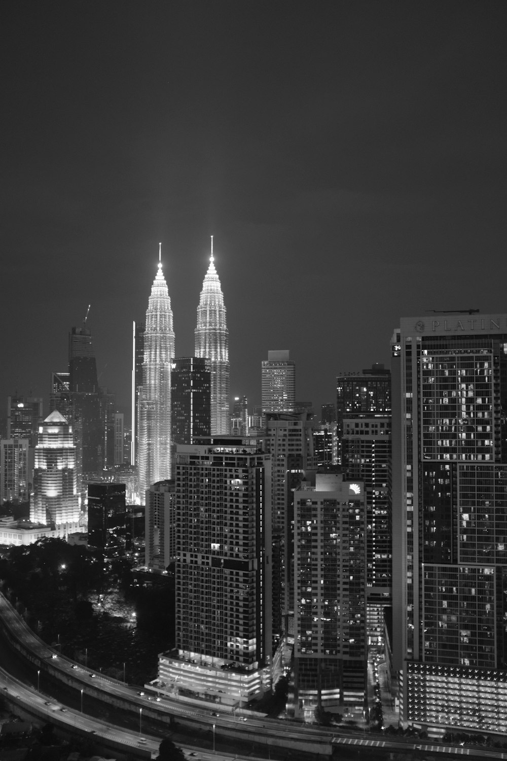 a black and white photo of a city at night