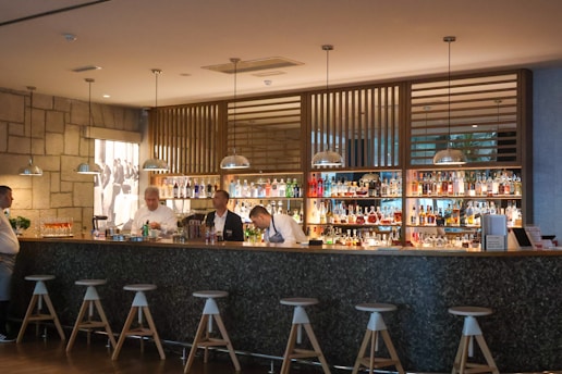 a group of people sitting at a bar