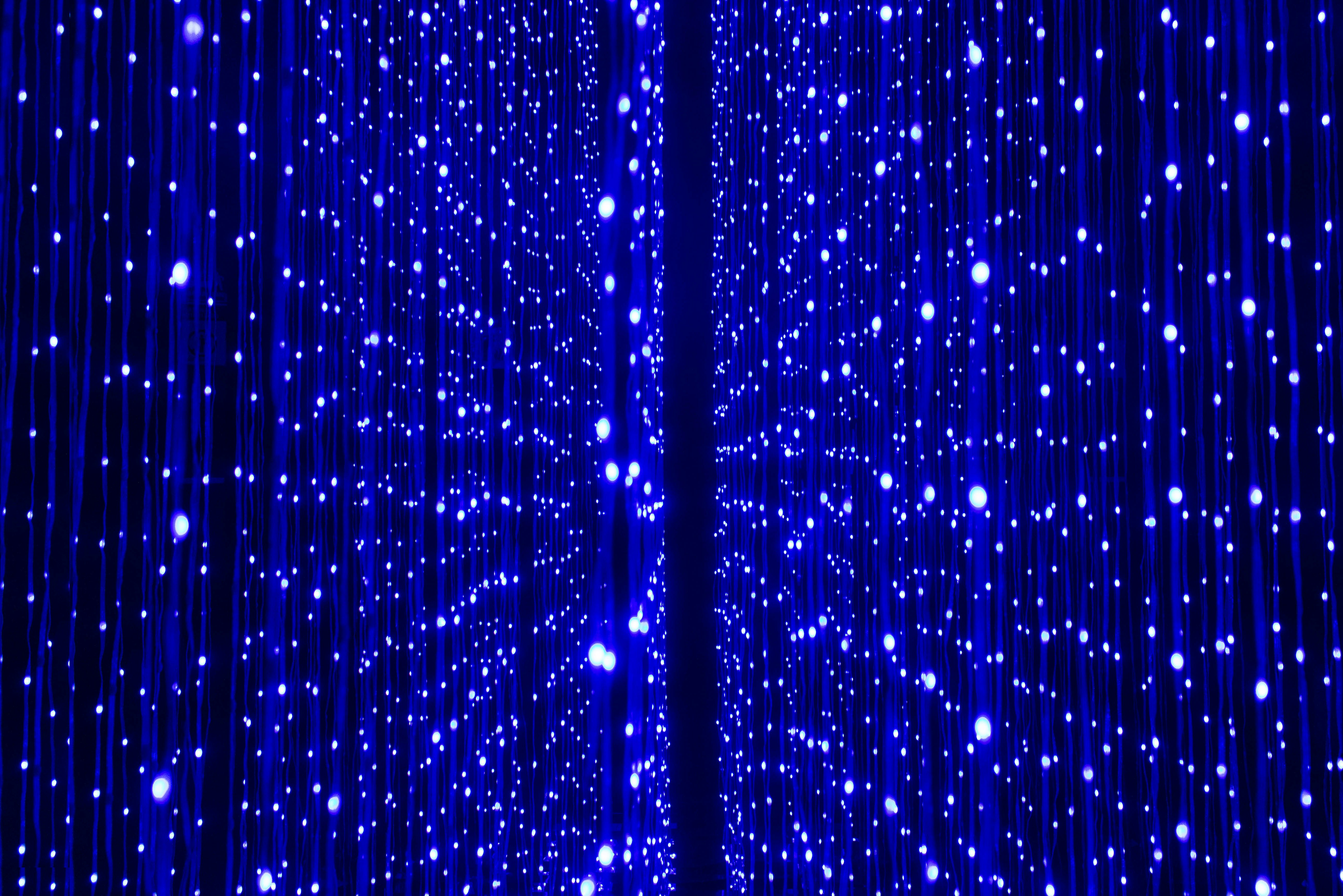 a blue curtain with white dots on it
