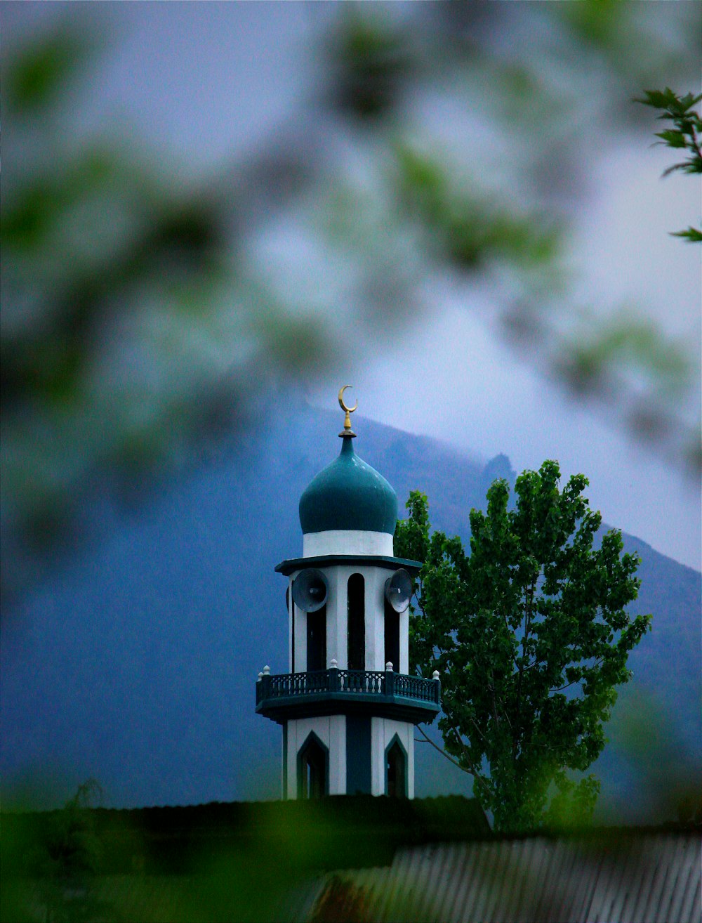 a white and blue tower with a clock on it