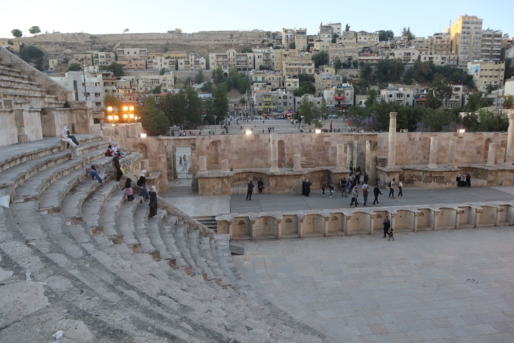 a group of people standing on top of a stone stage