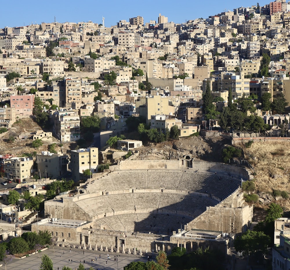 an aerial view of a city with a theatre in the middle