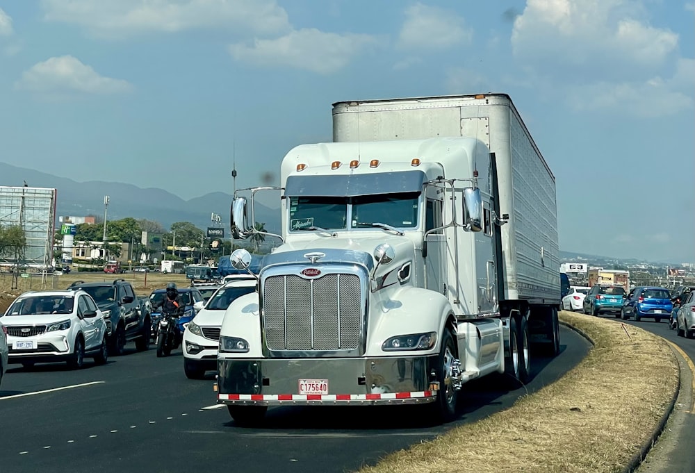 a large semi truck driving down a highway