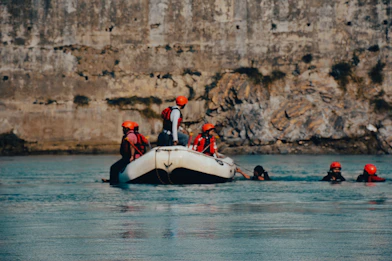 a group of people on a boat in the water