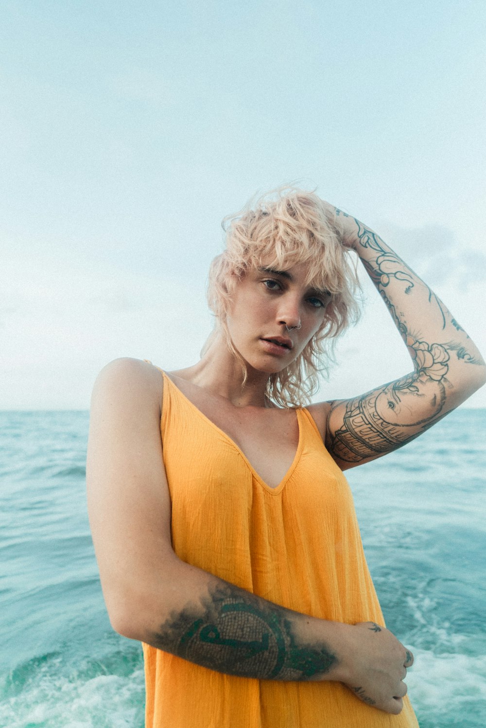 a woman in a yellow dress standing in the water