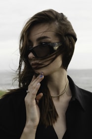a woman wearing sunglasses and a black shirt