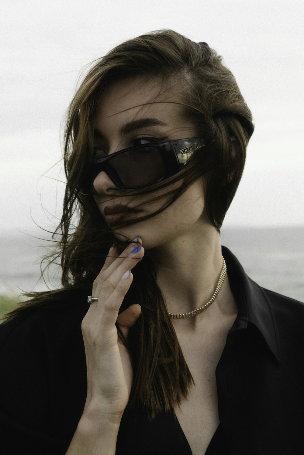 a woman wearing sunglasses and a black shirt