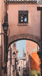 a narrow alleyway with an arched doorway