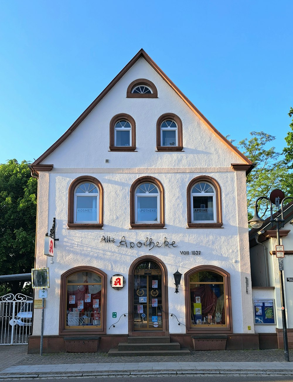 a white building with three windows on the front of it