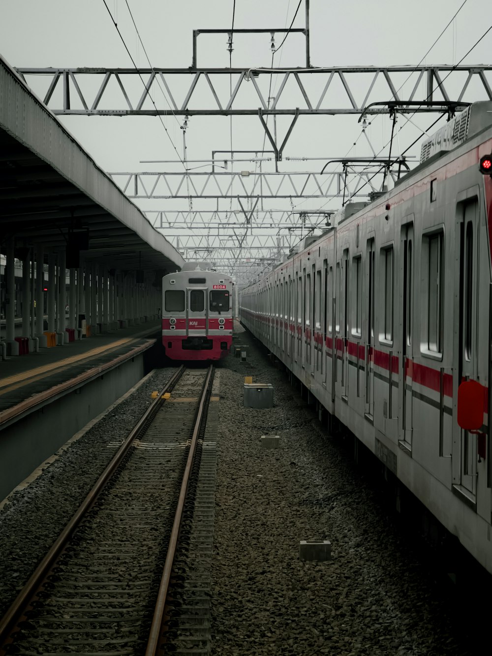 two trains parked next to each other in a train station