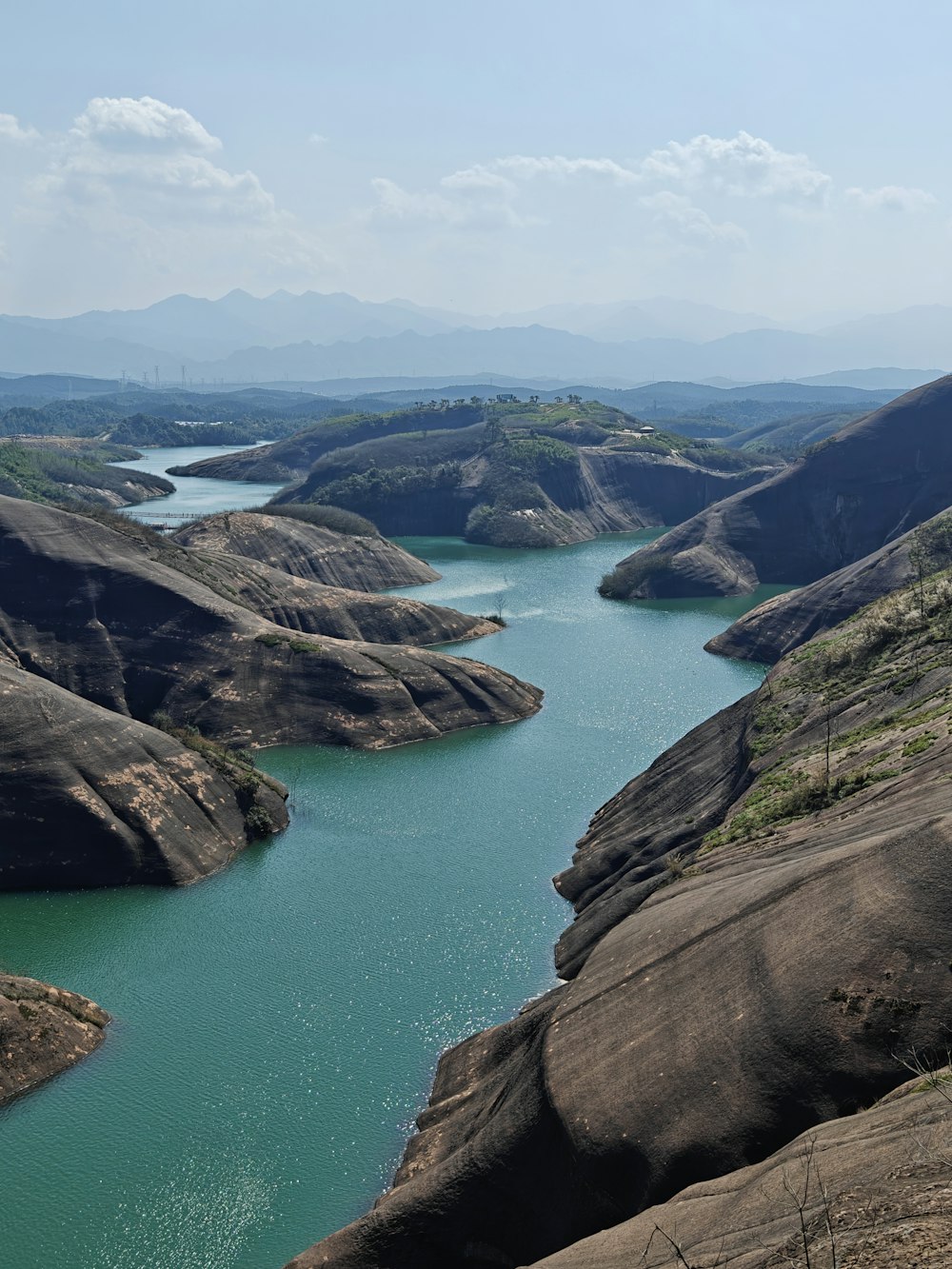 a river running through a valley surrounded by mountains