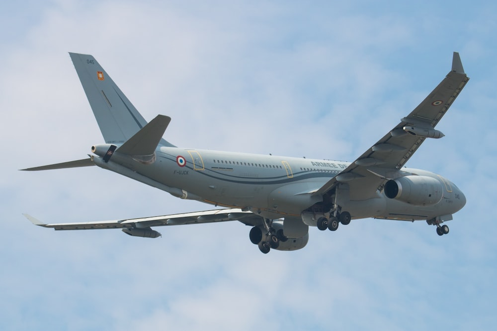 a large jetliner flying through a blue cloudy sky