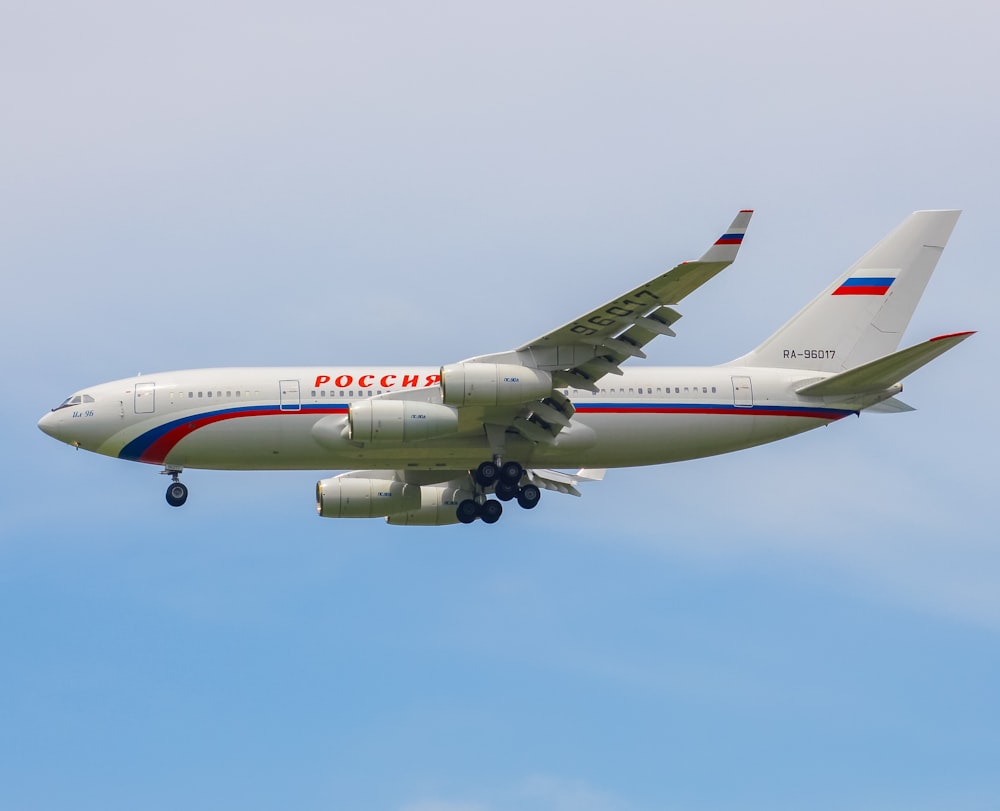 a large passenger jet flying through a blue sky