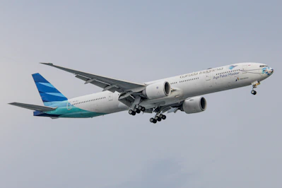a large passenger jet flying through a gray sky