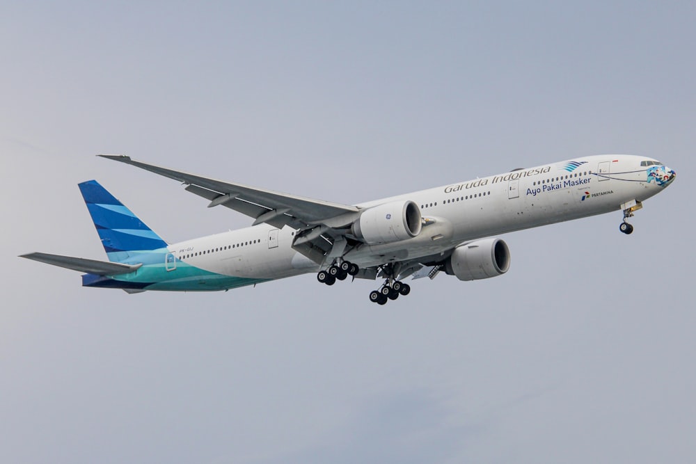 a large passenger jet flying through a gray sky