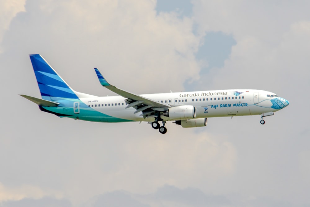 a large passenger jet flying through a cloudy sky