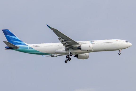 a large jetliner flying through a blue sky