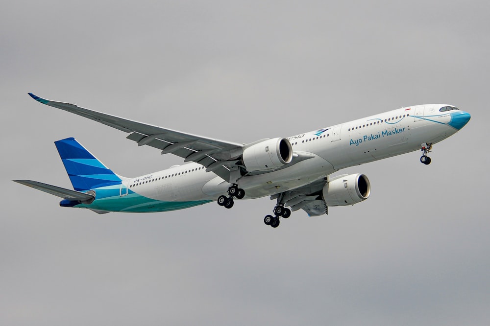 a large jetliner flying through a cloudy sky