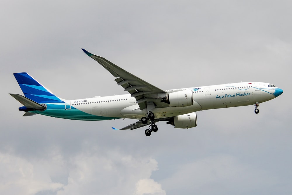 a large passenger jet flying through a cloudy sky