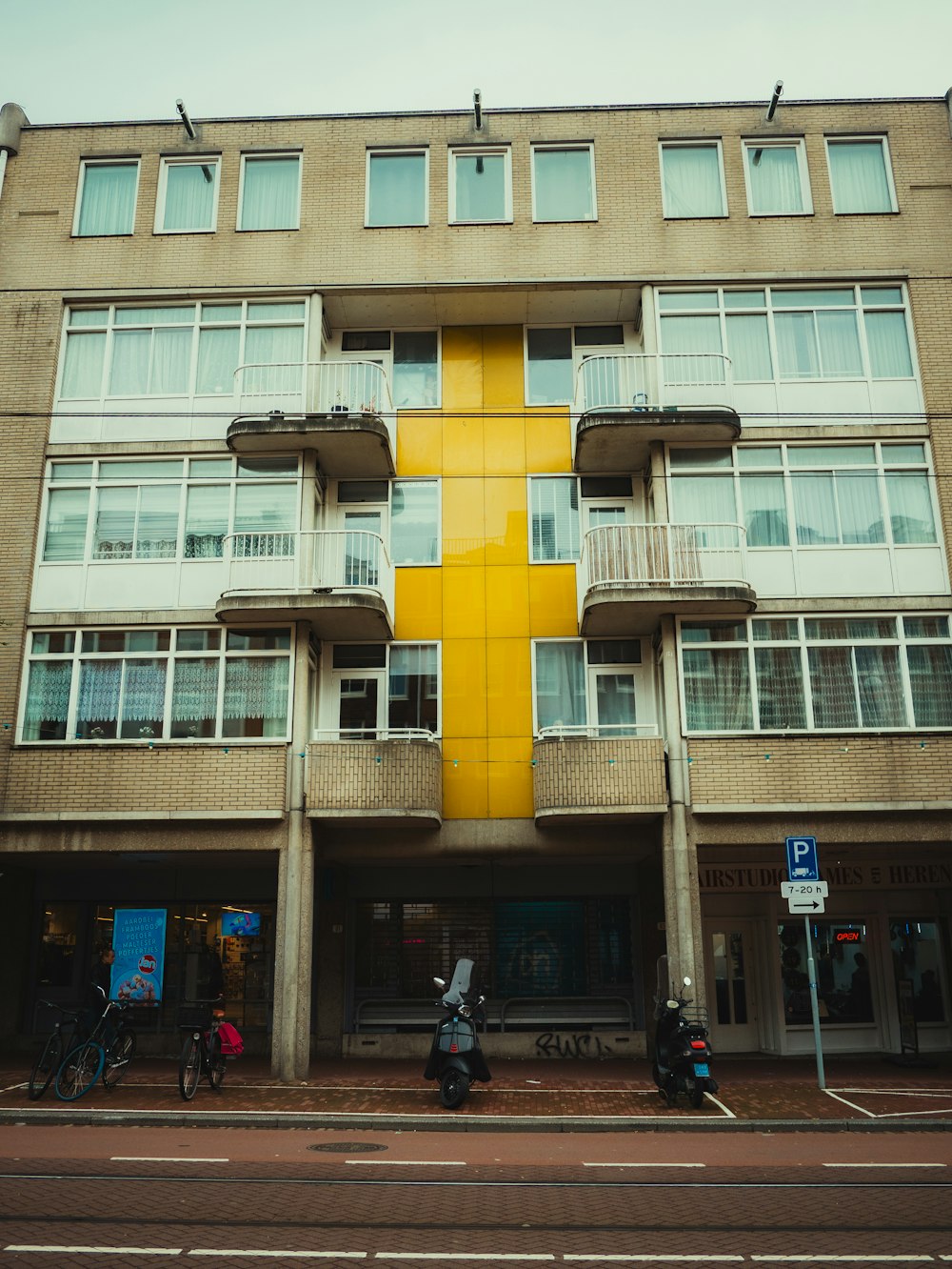 a tall building with a yellow cross on the side of it