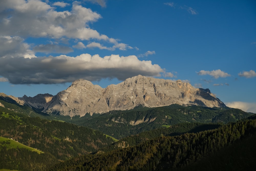 a view of a mountain range with clouds in the sky