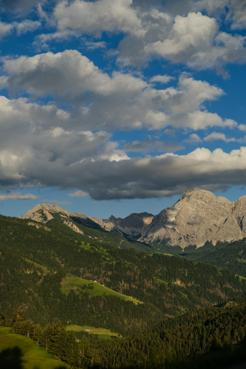 a view of a mountain range with clouds in the sky