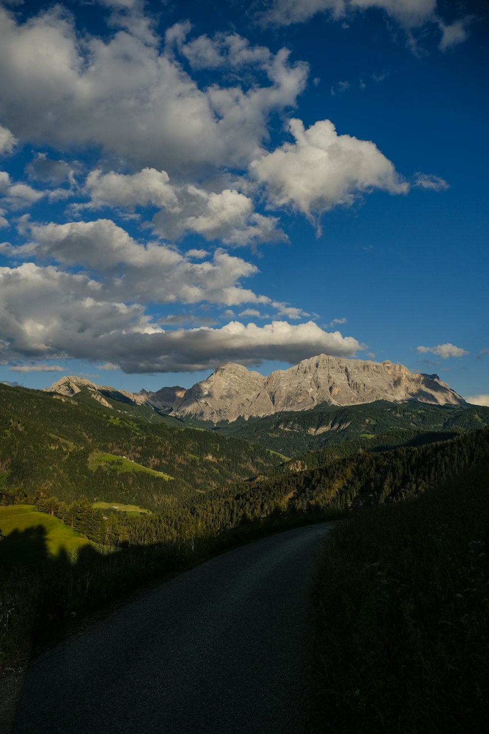 a scenic view of a mountain range with clouds in the sky