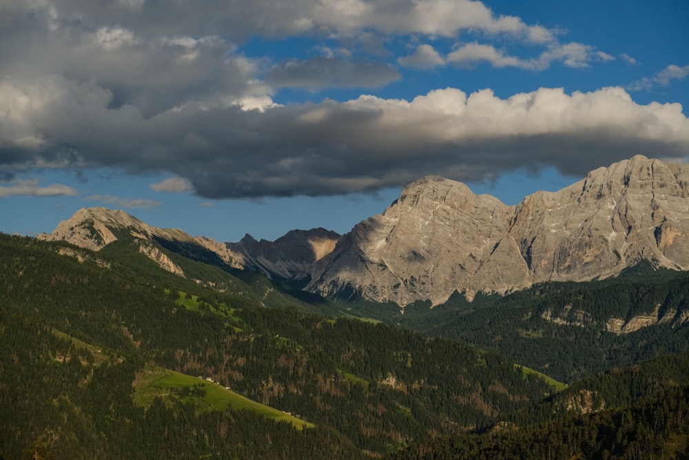 a view of a mountain range with clouds in the sky