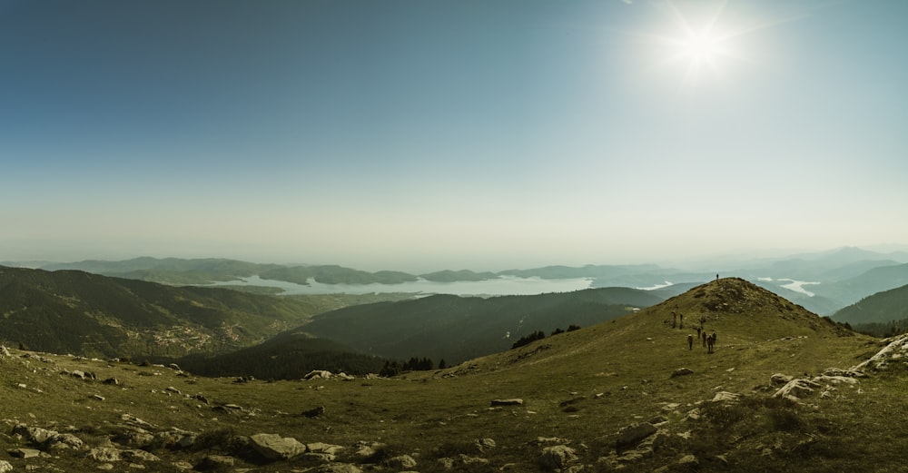 the sun is shining over a mountain range