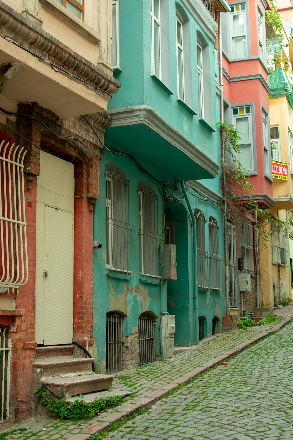 a cobblestone street lined with colorful buildings