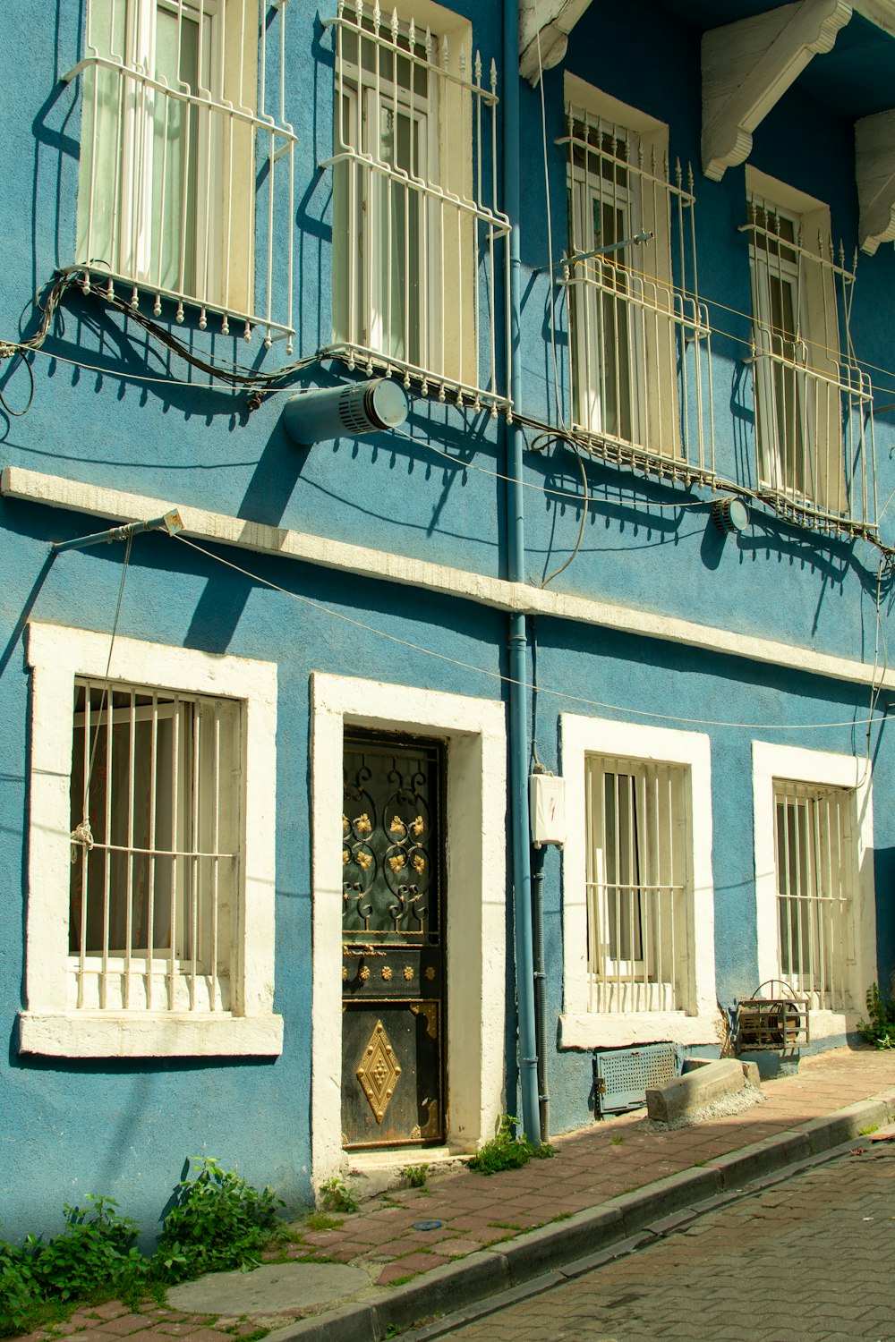 a blue building with white balconies and windows