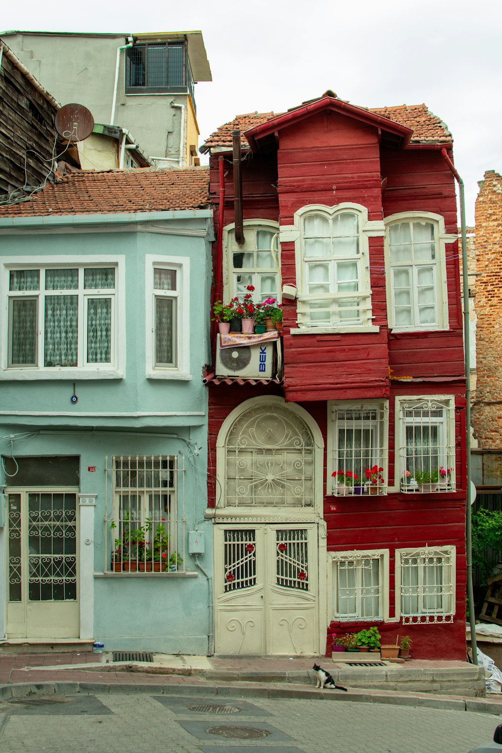 a red and blue building with white windows