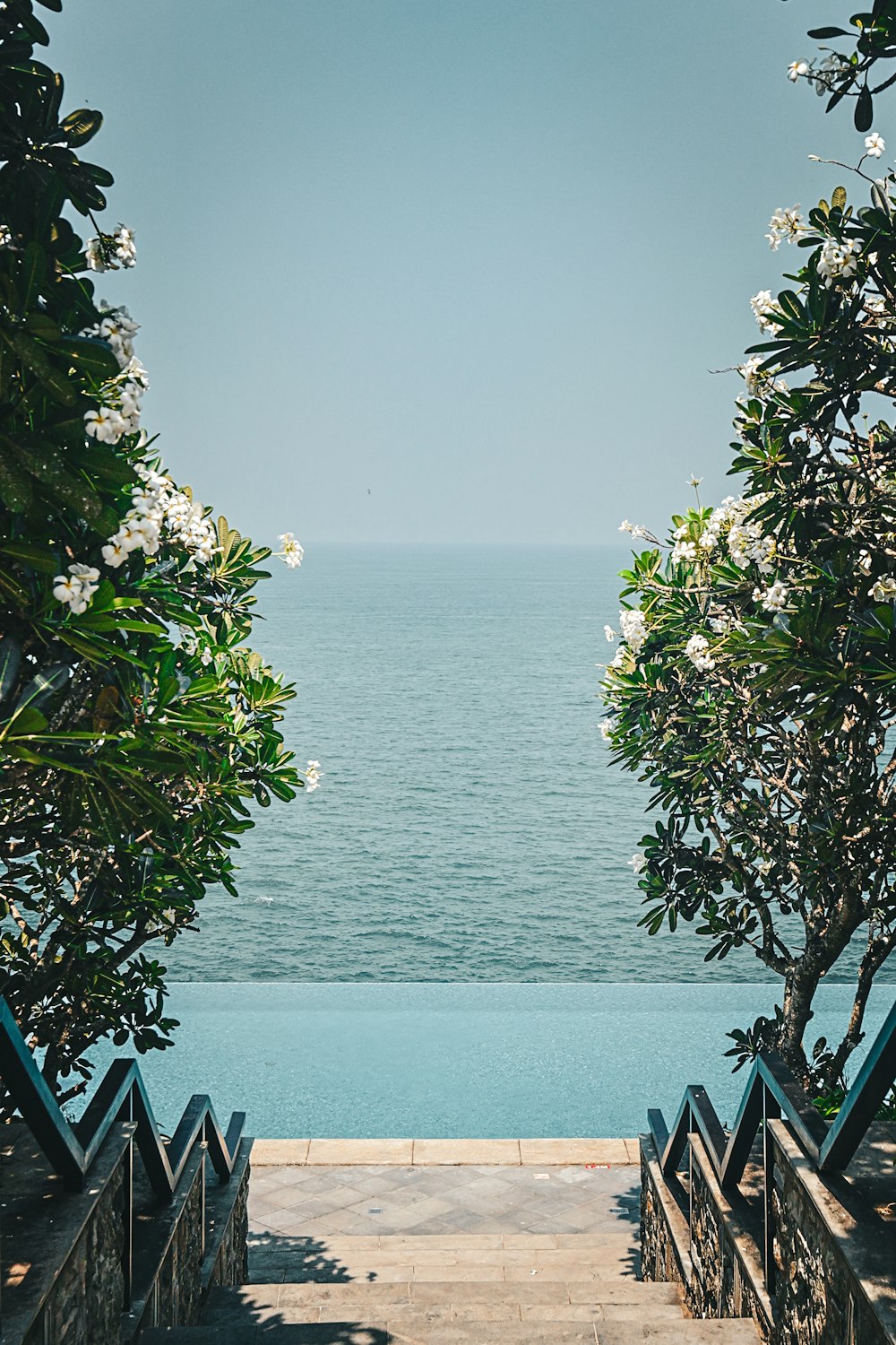 a view of the ocean from the top of a set of stairs