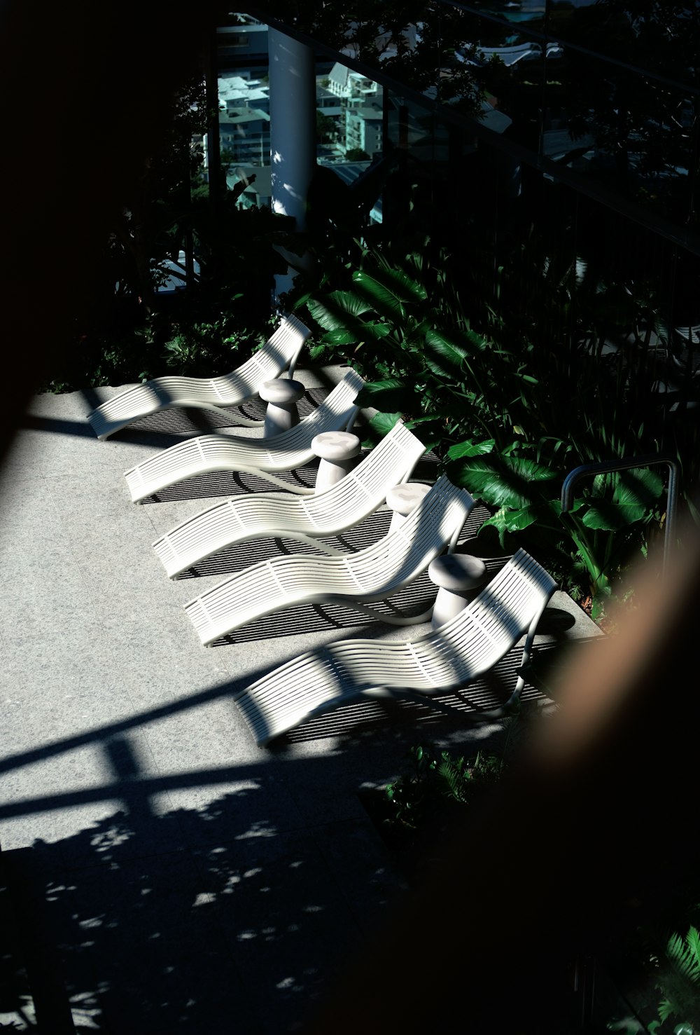 a row of white chairs sitting on top of a cement floor