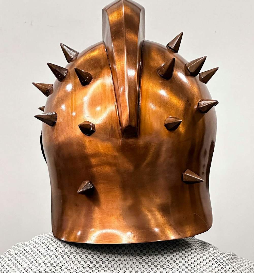 a close up of a helmet with spikes on it