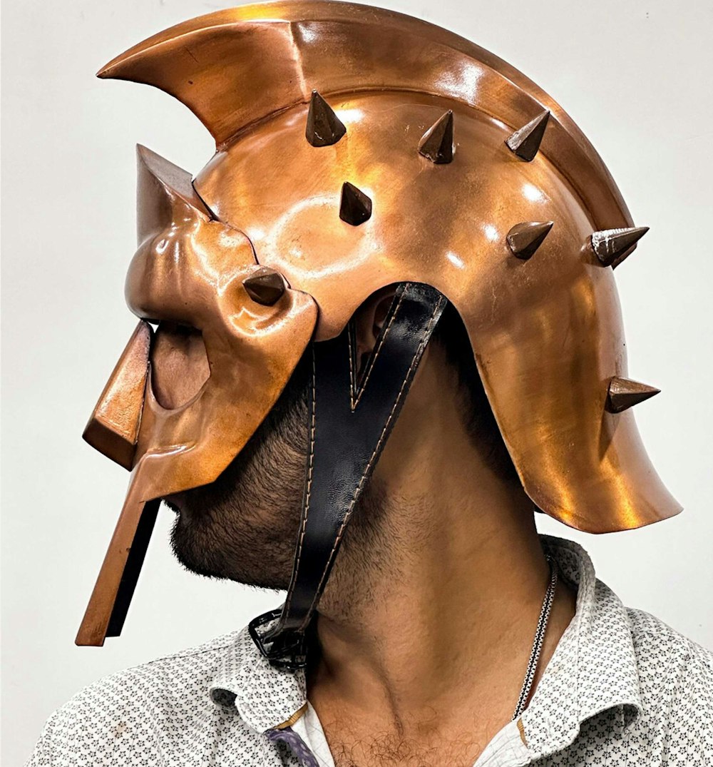 a man wearing a helmet with spikes on it