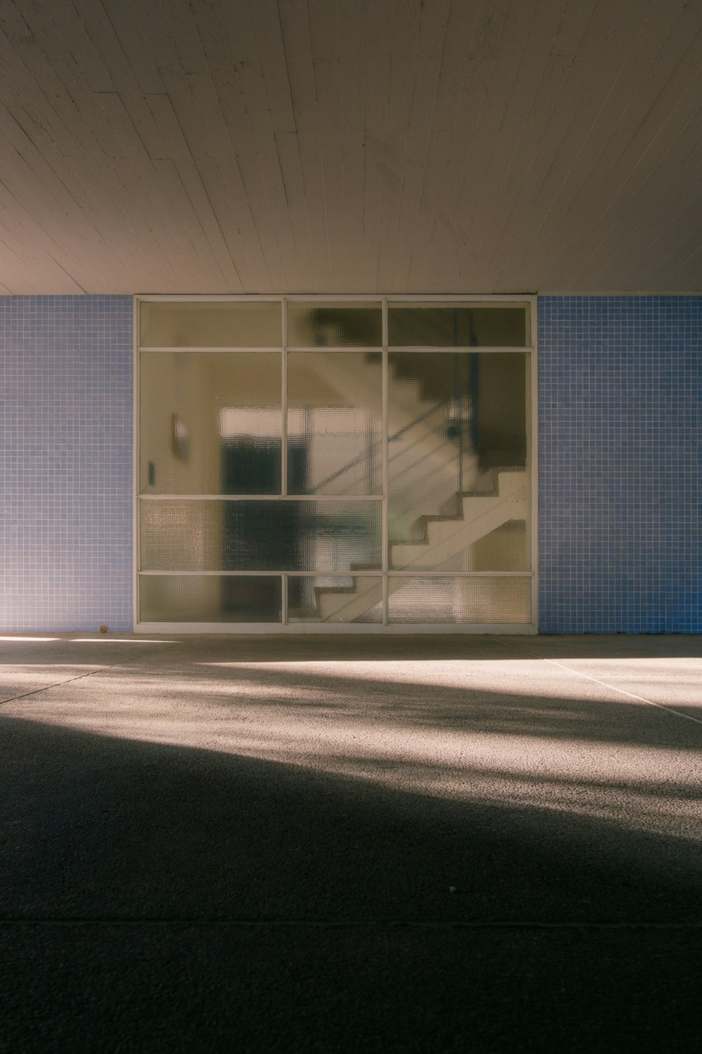 an empty parking lot with a skateboard in front of a building